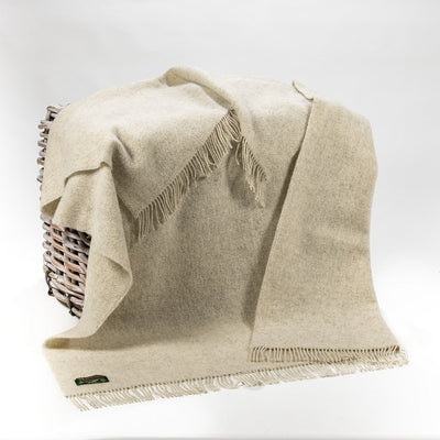 beige throw with matching beige wool fringing on 2 ends. .Made with undyed Wool so it has a very organic appearance.