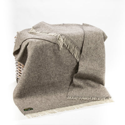 Mid grey throw with cream wool fringing on 2 ends..Made with undyed Wool so it has a very organic appearance