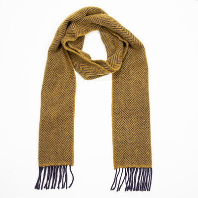 Mustard and navy herrinbone pattern on scarf with navy wool fringing on each short end