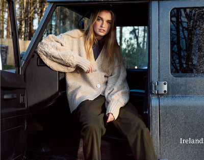 V neck cardigan for ladies with large oatmeal buttons to close. blouson sleeves make it contemporary with diamond stitch and cable stitch horizontally on sleeves from cuff to shoulder, Colour oatmeal. vey cool. moss stitch throughout main body of cardigan.
