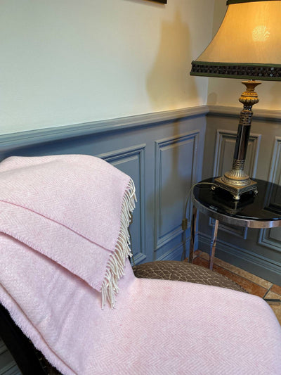 Pale pink herringbone throw with cream wool fringing on 2 edges