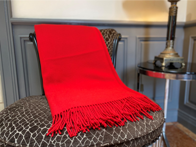 100% merino Wool throw . colour scarlet red . Fringing on either end . measurements 136cm x 180cm